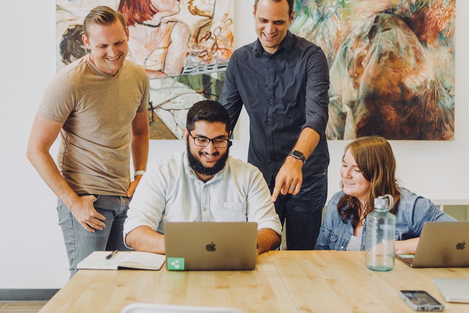 A small team looking at a laptop together